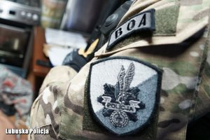 ramię policjanta z oddziałów specjalnych z herbem policji