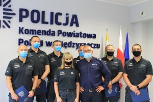 inspektor Paweł Rynkiewicz - Komendant Komendy Powiatowej Policji w Międzyrzeczu wraz z funkcjonariuszami Aresztu Śledczego w Międzyrzeczu w trakcie oficjalnych podziękowań za wzorową postawę. Zdjęcie pamiątkowe wykonane w sali odpraw Komendy Powiatowej Policji w Międzyrzczu