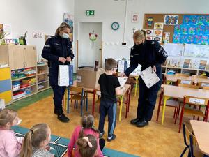Policjantki wręczające nagrodę dla dziecka, którego praca wygrała w konkursie LUPO.